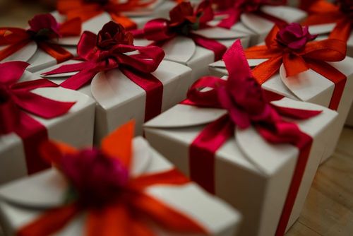 White gift boxes finished with red ribbon bows